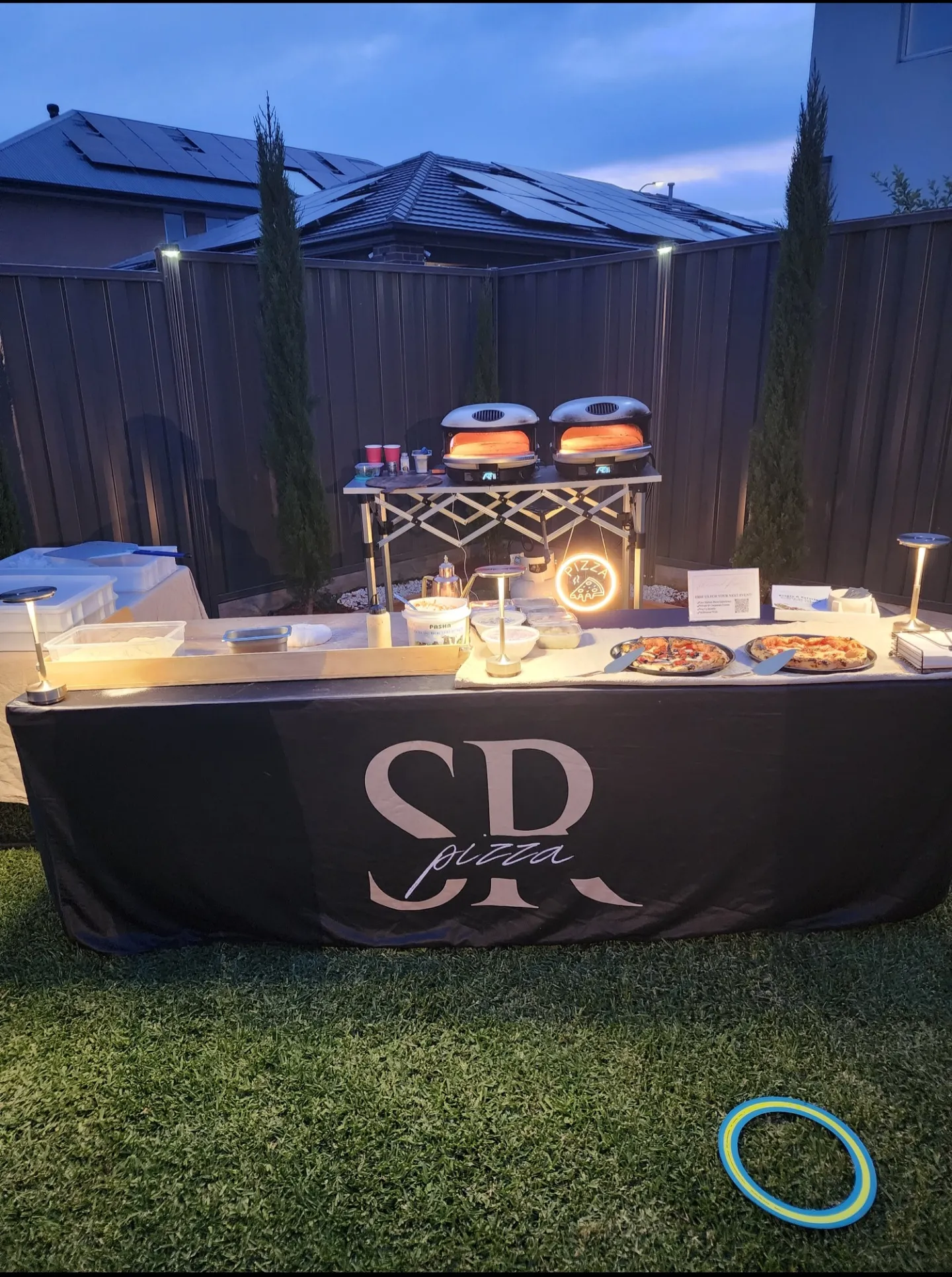 SR Pizza evening event setup with stone-fired ovens