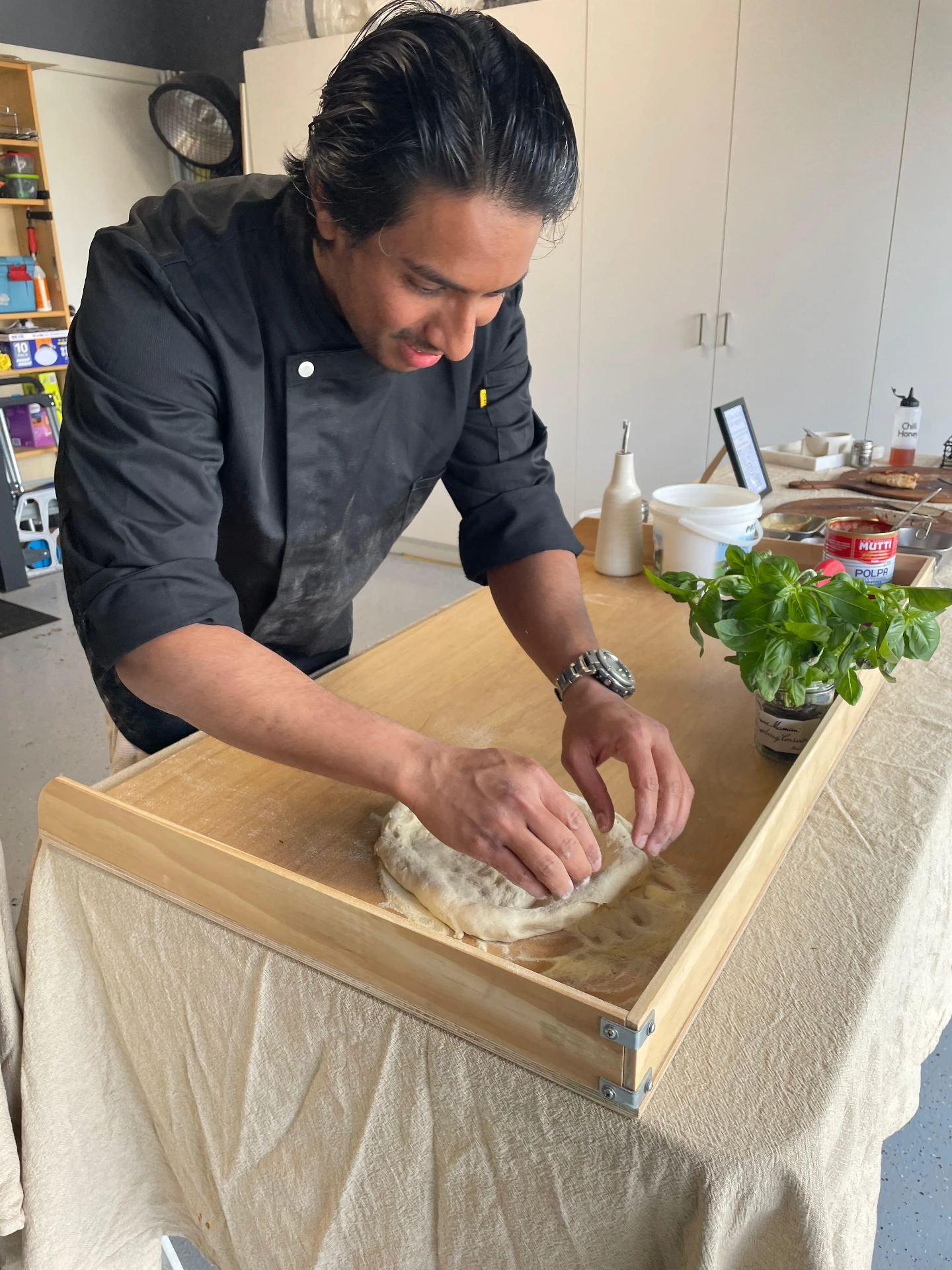 SR Pizza chef hand-stretching 36-hour fermented dough